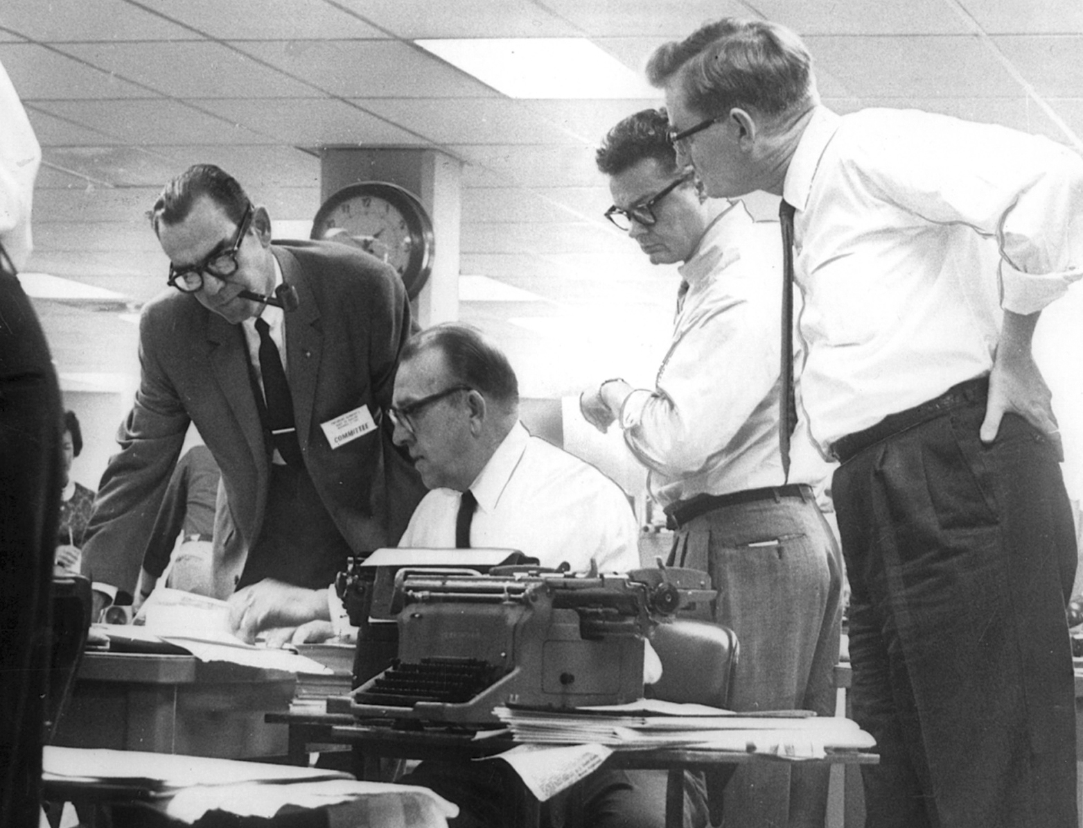 Felix R. McKnight, editor, working on the John F. Kennedy assassina tion page in the Dallas Times Herald newsroom, Nov. 22, 1963. Far left is James Chambers, Jr. co-publisher, Blackie Sherrod standing next to McKnight. Far right is A.C. Green